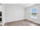 Empty bedroom features wood-look floors, a large window, and fresh white paint at 317 Miramar Dr, York, SC 29745