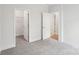Bright bedroom with neutral carpet, walk-in closet, and white trim at 317 Miramar Dr, York, SC 29745