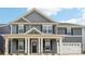 Charming two-story home with gray siding, a covered front porch, and manicured landscaping at 317 Miramar Dr, York, SC 29745