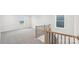 Hallway with carpet, wood and iron railing, and view to window at 317 Miramar Dr, York, SC 29745