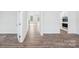 Hallway features wood-look floors and white trim, connecting various parts of the home at 317 Miramar Dr, York, SC 29745
