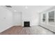 Cozy living room with a fireplace, hardwood flooring, and large windows providing ample light at 317 Miramar Dr, York, SC 29745