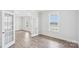 Bright living room with wood-look floors, glass paneled doors, and a large window at 317 Miramar Dr, York, SC 29745
