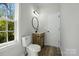 Bathroom featuring a modern vanity, stylish light fixture, and a large window, blending style and natural light at 414 Clinton Ave, Lancaster, SC 29720