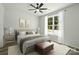 A modern bedroom is staged with an oversized bed and neutral decor at 414 Clinton Ave, Lancaster, SC 29720