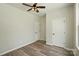 Bedroom with neutral tones, wood-look floors, and multiple closets, offering a simple yet functional space at 414 Clinton Ave, Lancaster, SC 29720