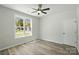 Bright bedroom with a large window offering neighborhood views, complemented by sleek wood-look floors and modern finishes at 414 Clinton Ave, Lancaster, SC 29720