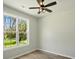 Bright bedroom with a ceiling fan and a large window offering natural light and backyard views, creating a warm ambiance at 414 Clinton Ave, Lancaster, SC 29720