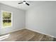 Bright bedroom with a window and wood-look floors, offering a simple and inviting space with natural light at 414 Clinton Ave, Lancaster, SC 29720