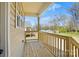 View of a home's cozy wooden deck and railing with green outdoor scenery at 414 Clinton Ave, Lancaster, SC 29720
