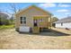 Charming exterior view of a tan home with front porch and wooden staircase at 414 Clinton Ave, Lancaster, SC 29720