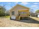 Side view of a house featuring a cozy covered porch and wooden stairs at 414 Clinton Ave, Lancaster, SC 29720