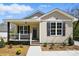 Charming home features a welcoming porch, black shutters, and well-maintained landscaping at 414 Clinton Ave, Lancaster, SC 29720