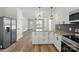 Modern kitchen with an island, stainless steel appliances, granite countertops and updated fixtures at 414 Clinton Ave, Lancaster, SC 29720