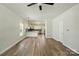 Open-concept living space with wood-look floors seamlessly connects the living room and kitchen at 414 Clinton Ave, Lancaster, SC 29720