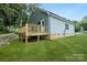 Back exterior featuring a wooden deck attached to a light-colored siding of the single Gathering home at 602 Meadow Ave, Spencer, NC 28159