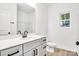 Bright bathroom with white countertop, gray cabinets, black hardware, and a window at 602 Meadow Ave, Spencer, NC 28159