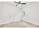 Bright, carpeted bedroom featuring a window, white walls, and a dark door at 602 Meadow Ave, Spencer, NC 28159
