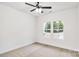 Bright, carpeted bedroom with large windows offering views of the outdoors and a ceiling fan at 602 Meadow Ave, Spencer, NC 28159