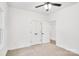 Carpeted bedroom with white walls, a ceiling fan, and a double-door closet at 602 Meadow Ave, Spencer, NC 28159
