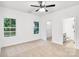 Bright bedroom with neutral carpet, a ceiling fan, and natural light from two windows at 602 Meadow Ave, Spencer, NC 28159