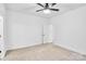 Spacious bedroom with neutral carpet, white walls, ceiling fan, and ensuite bath at 602 Meadow Ave, Spencer, NC 28159