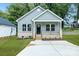 A cozy single-story house with a light-colored exterior, a small porch, and a well-maintained front yard at 602 Meadow Ave, Spencer, NC 28159