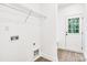 Laundry room with washer and dryer hookups, wire shelving, and a rear access door at 602 Meadow Ave, Spencer, NC 28159
