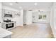 Open floor plan featuring a modern kitchen and dining area, complemented by beautiful, light wood flooring at 602 Meadow Ave, Spencer, NC 28159