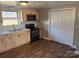 Galley kitchen with wood cabinets and black appliances at 1129 Rita Ave, Statesville, NC 28677