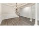 Elegant dining area with hardwood flooring, a chandelier, and staircase access at 8511 Castledown Dr, Huntersville, NC 28078