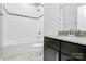 Clean bathroom with white tile, granite vanity, and tub at 11712 Blessington Rd, Huntersville, NC 28078