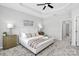 Bright bedroom with carpeted floor, ceiling fan, and large bed at 11712 Blessington Rd, Huntersville, NC 28078