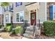 Detailed view of townhome entrance with stone steps and landscaping at 11712 Blessington Rd, Huntersville, NC 28078
