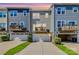 Rear view of townhomes showcasing private decks and attached garages at 11712 Blessington Rd, Huntersville, NC 28078