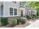 Townhome featuring stone accents, landscaping, and a welcoming front entrance at 11712 Blessington Rd, Huntersville, NC 28078