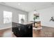 Kitchen island with granite countertop and dark cabinetry in an open concept space at 11712 Blessington Rd, Huntersville, NC 28078