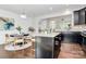 Open concept kitchen with island and breakfast area, granite countertops, and dark cabinetry at 11712 Blessington Rd, Huntersville, NC 28078