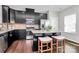Modern kitchen with dark cabinetry, granite countertops, and stainless steel appliances at 11712 Blessington Rd, Huntersville, NC 28078