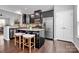Modern kitchen with dark cabinetry, granite island, and stainless steel appliances at 11712 Blessington Rd, Huntersville, NC 28078