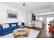 Living room with blue sofa, wood coffee table, and hardwood floors at 11712 Blessington Rd, Huntersville, NC 28078