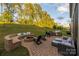 Inviting outdoor patio with a fire pit, built-in seating, grilling area, and comfortable lounge space at 16827 Monocacy Blvd, Huntersville, NC 28078