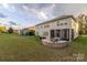 Expansive backyard features a fire pit, patio, screened in porch and plenty of green space at 16827 Monocacy Blvd, Huntersville, NC 28078