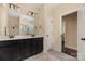 Bathroom featuring dual vanity sinks, tile floors, and a decorative shower curtain at 16827 Monocacy Blvd, Huntersville, NC 28078