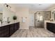 This bathroom features double vanities, walk-in shower and tile floors at 16827 Monocacy Blvd, Huntersville, NC 28078