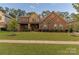 Beautiful two-story home featuring a well-maintained lawn, stone accents, and inviting curb appeal at 16827 Monocacy Blvd, Huntersville, NC 28078