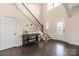 Elegant foyer with hardwood floors, staircase, decorative console table, and natural light at 16827 Monocacy Blvd, Huntersville, NC 28078