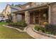 Charming covered front porch with stone pillars, a well-kept garden, and inviting entryway at 16827 Monocacy Blvd, Huntersville, NC 28078