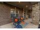 Inviting front porch with stone columns, rocking chairs, and colorful decor offering a cozy welcome at 16827 Monocacy Blvd, Huntersville, NC 28078