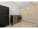 Laundry room with a modern washer and dryer set, tile floors, and decorative laundry art at 16827 Monocacy Blvd, Huntersville, NC 28078